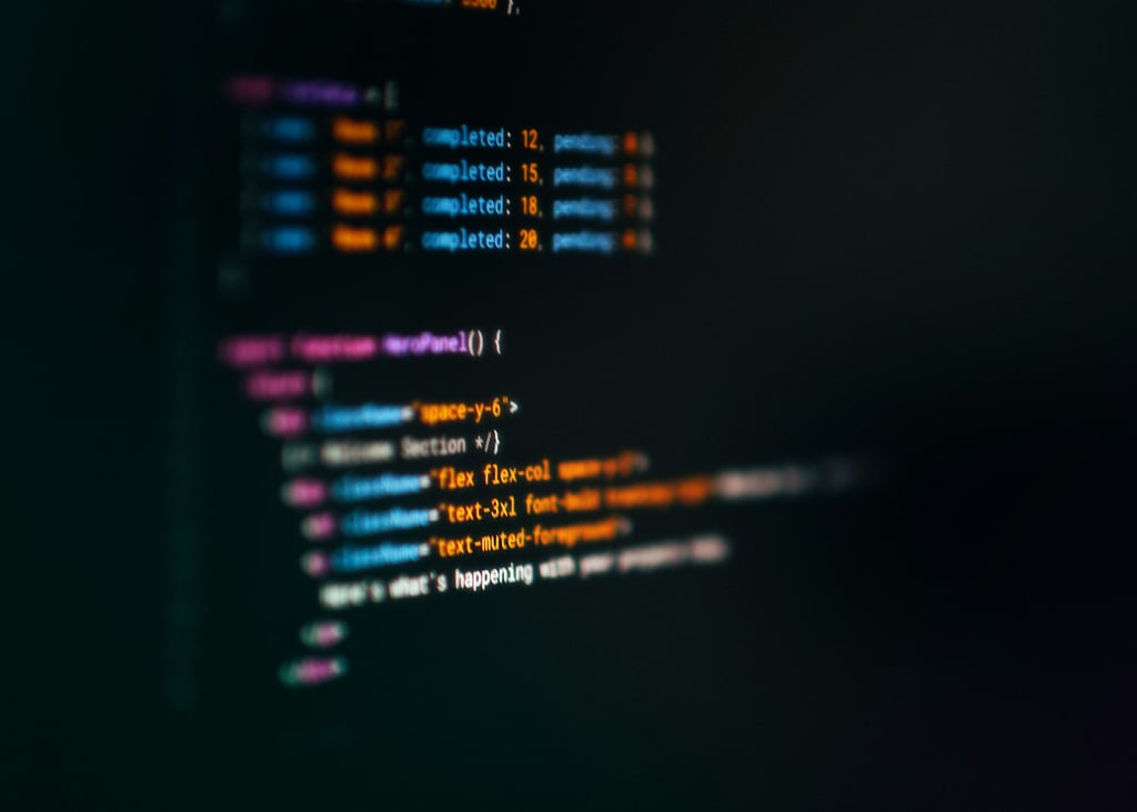 Dataskjerm som viser fargerik JSX-kode i en mørk kodeeditor