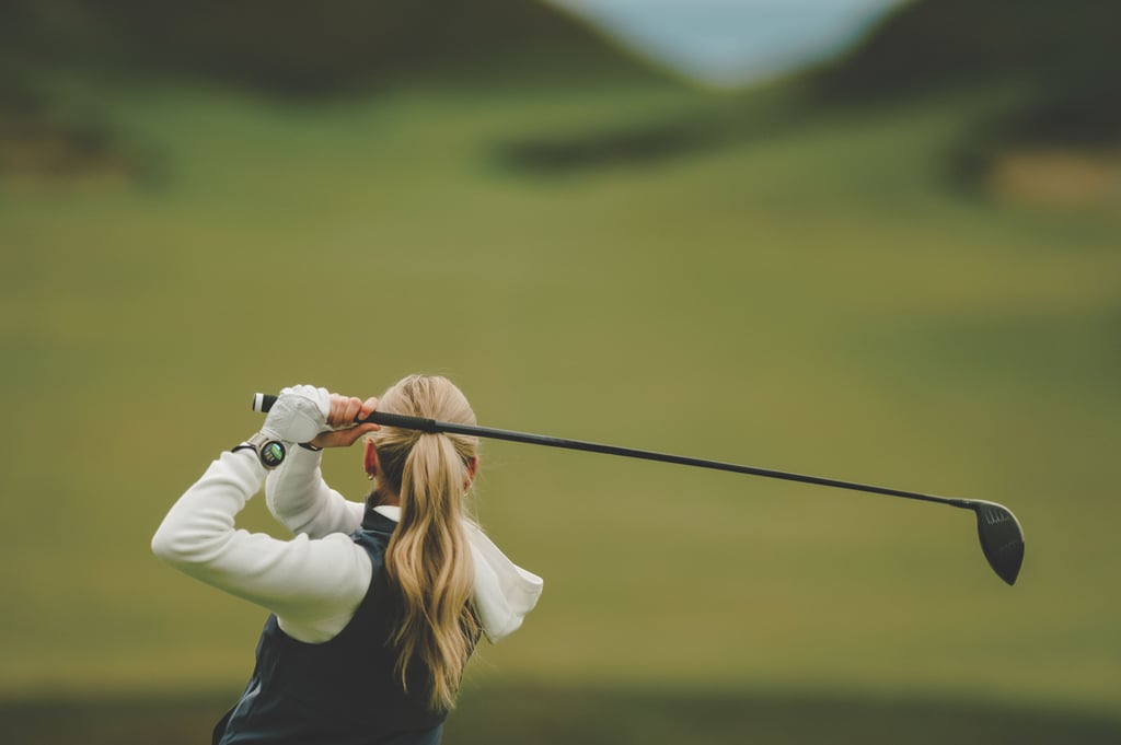 Golfspiller sett bakfra etter et utslag med driver, med Garmin Approach S72 på venstre håndledd