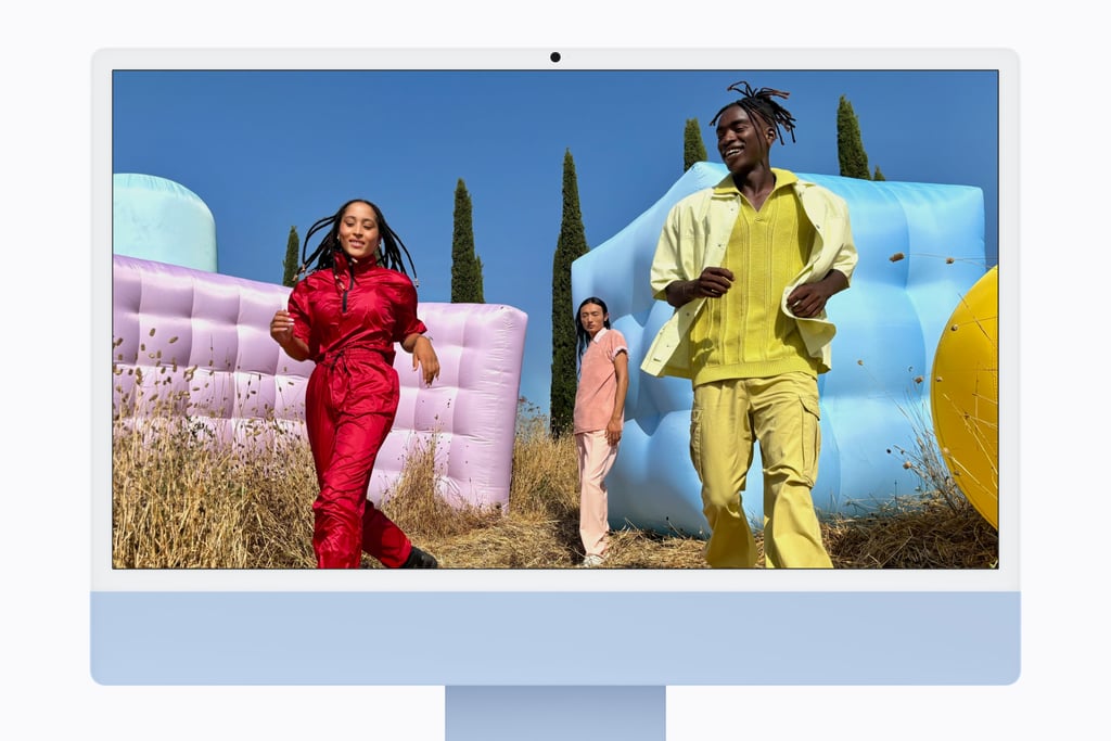 Blå iMac med et farvesterkt bilde av to dansere på skjermen