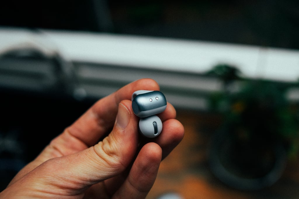 Nærbilde av motvekten på Shokz OpenDots 2 holdt mellom to fingre